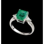 A ringGoldSet with one emerald (ca.2.10ct) and two triangle cut diamonds totalling (ca.0.50ct)Oporto