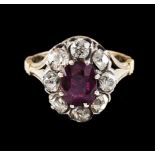 A ringGold and silverSet with an oval cut ruby (ca.7,5x6mm) and 8 antique cut diamonds totalling (