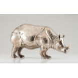 A large Manuel Alcino rhinocerosRepoussé and chiselled Portuguese silver sculpture with applied