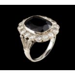 A ringGoldSet with one onyx (ca.18x10mm) framed by 16 brilliant cut diamonds totalling (ca.1.10ct)