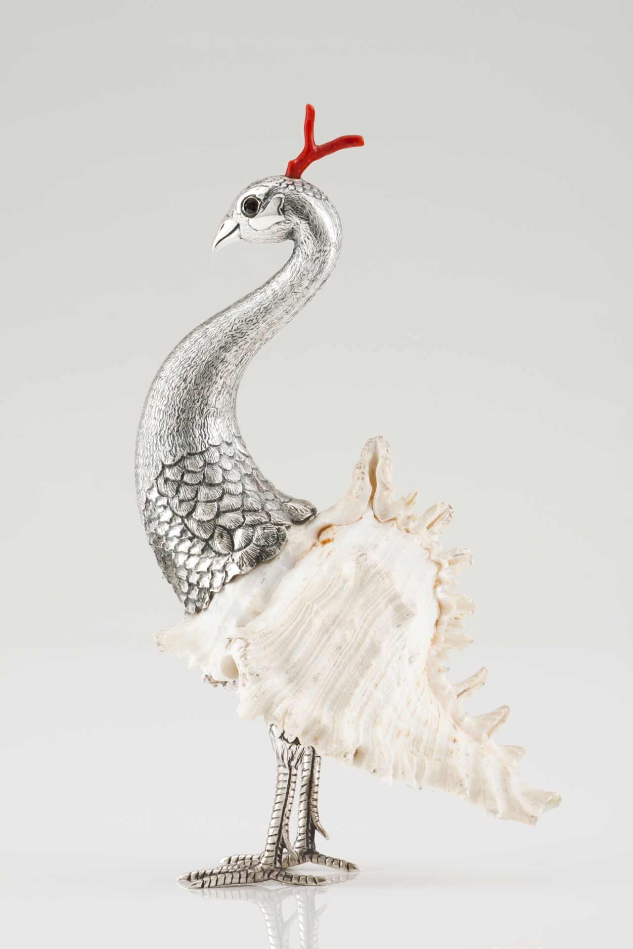 A peacockSilverMoulded and engraved decoration mounted on a shellGlass eyes and dyed shell
