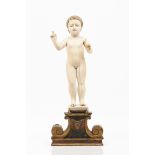 A Baby JesusSinhalese-Portuguese ivory sculptureOn a carved and polychrome wooden stand18th