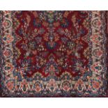 A Kerman rug, IranWool and cotton, of floral pattern in bordeaux, blue and beige355x222 cm