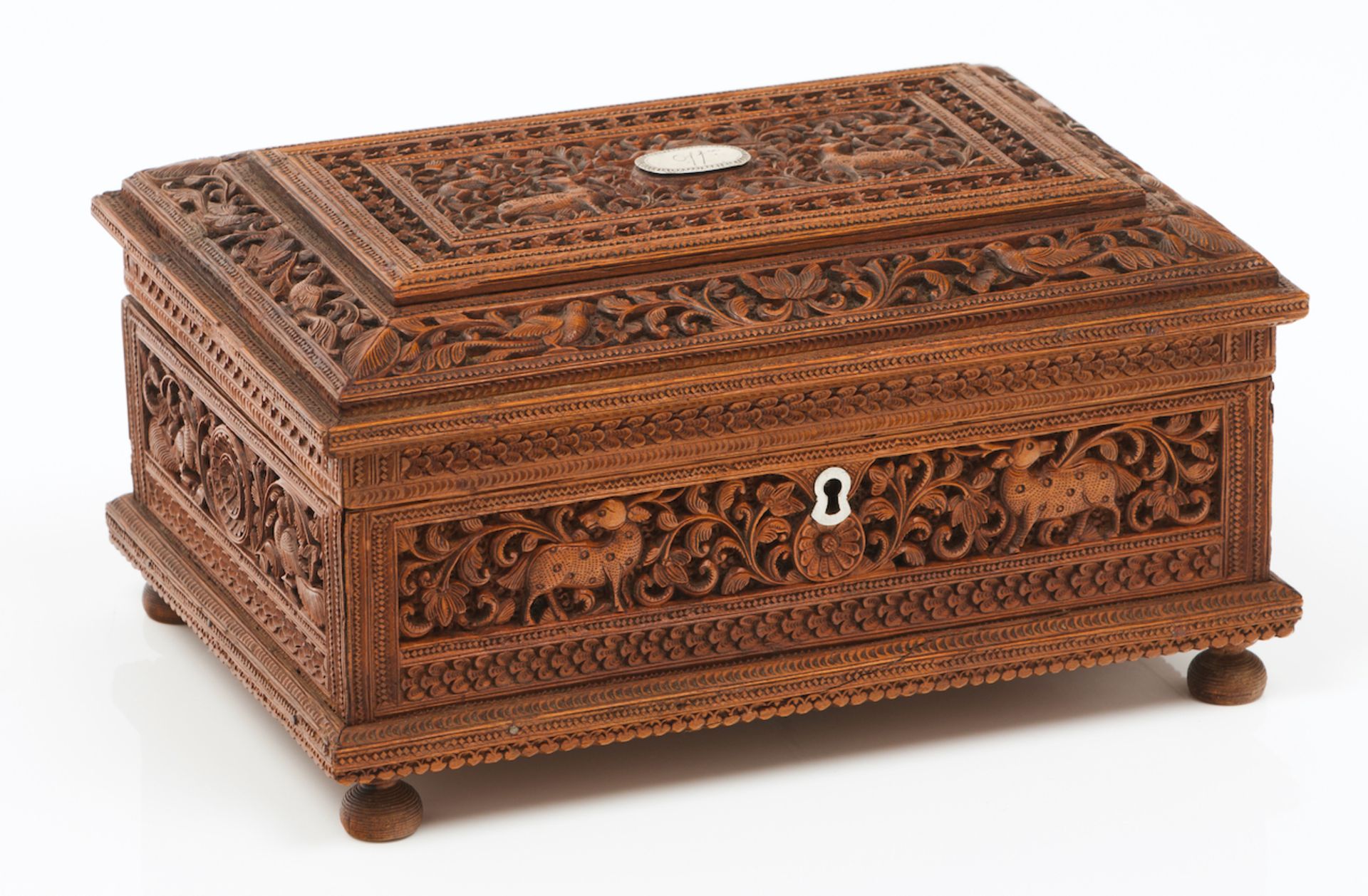 An Anglo-Indian boxCamphor woodProfusely carved decoration of floral motifs and animalsSilvered