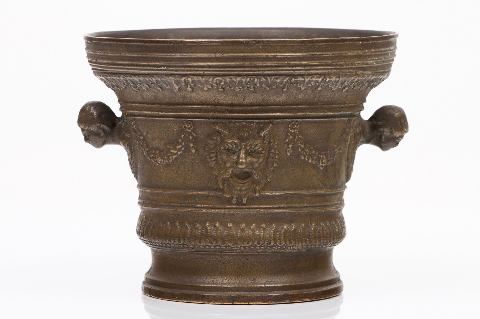 A large mortarRaised bronze with classical masks and flower garlandsInscribed MDCXXXEurope, 17th