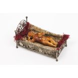 A dormant Baby JesusIndo-Portuguese ivory sculpturePierced silver crib with flowers, baluster