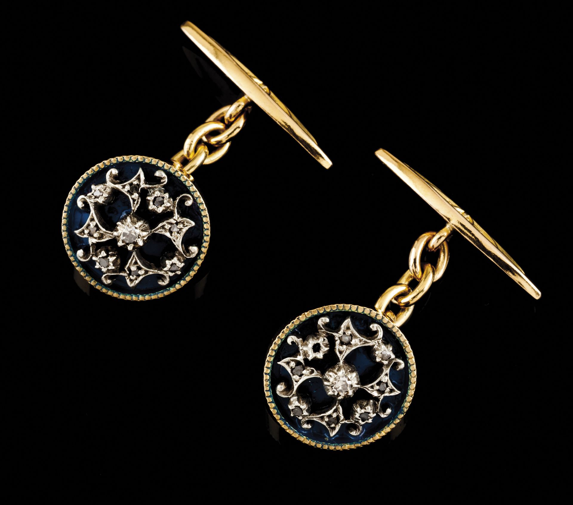 A pair of cufflinksGold and silverCircular shaped of blue enamelled background with silver applied