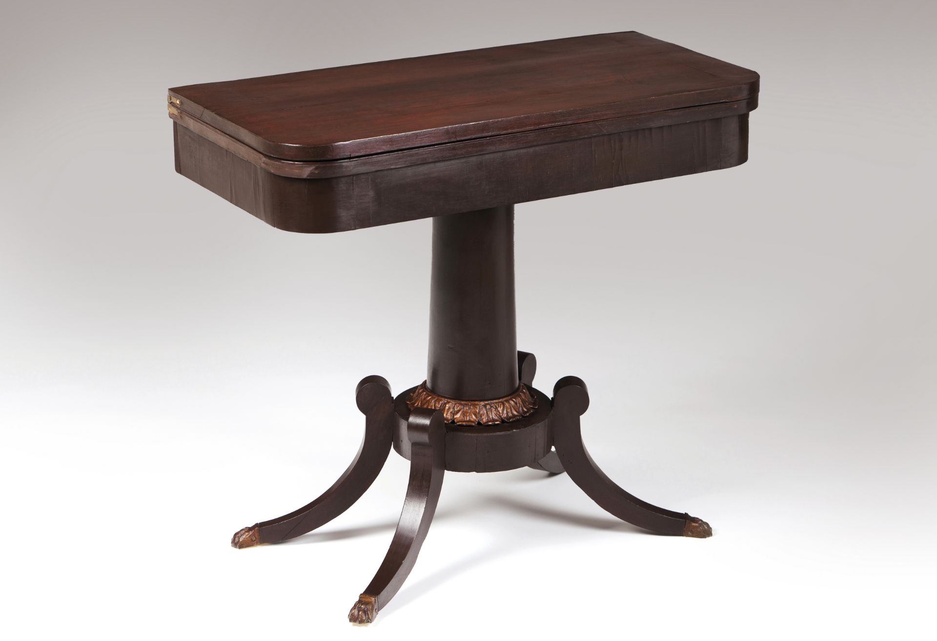 An Empire style card tableMahoganyCentral stand ending in carved and gilt decorationClaw feetGreen