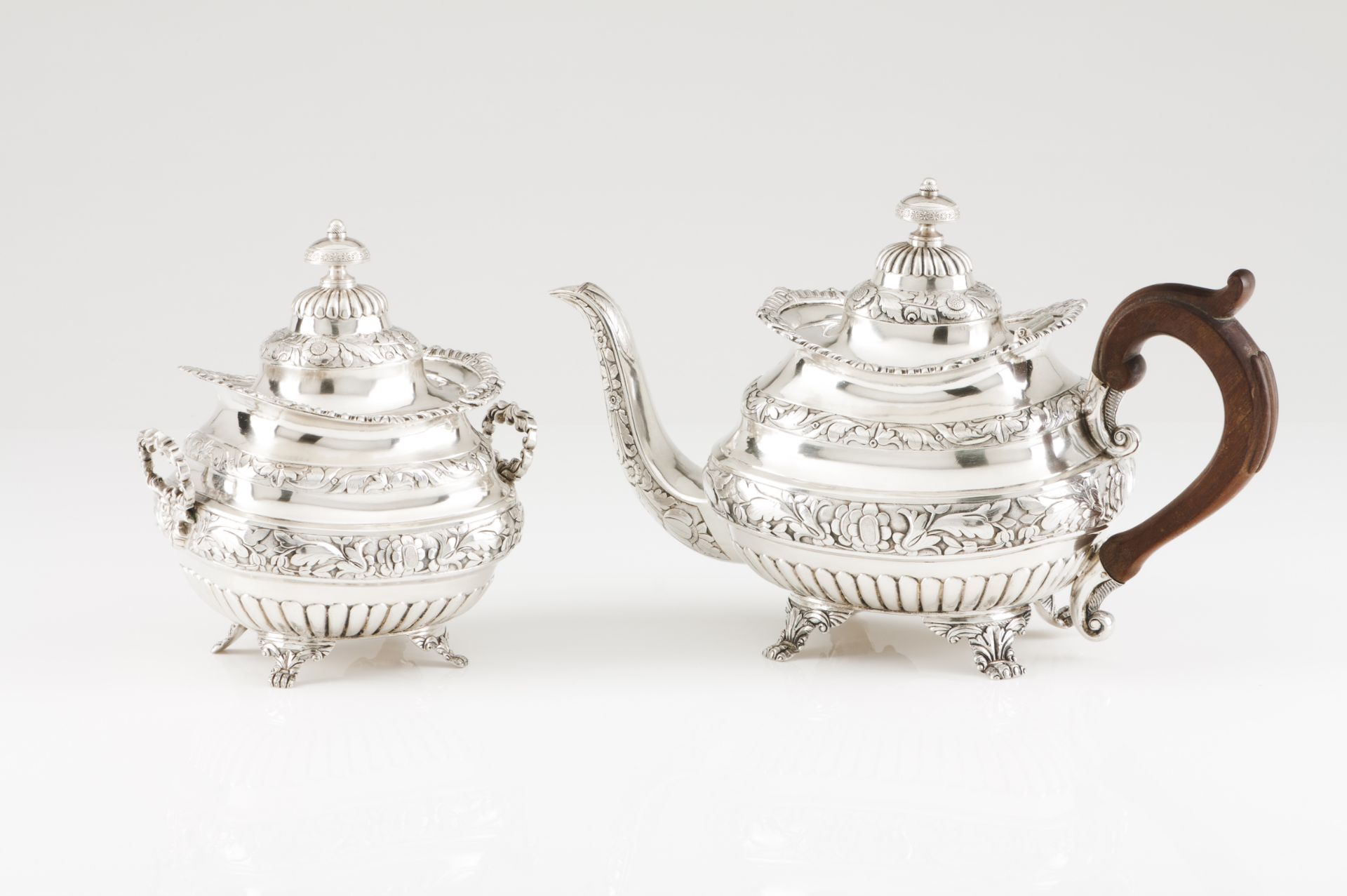 A mid-19th century Portuguese silver tea pot and sugar bowlRaised on claw feet, fluted and relief