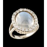 A ringGoldSet with one moonstone (ca.15x11mm) framed by 21 Brilliant cut diamonds totalling (ca.0.