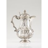 A jug with coverPortuguese silverBaluster body of spiralled decoration with winglets, flowers and