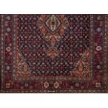 A Veramin rug, IranWool and cotton of geometric design in blue and bordeaux316x246 cm