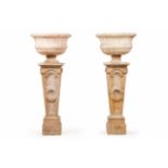 A pair of large vases with pedestalsCarved marbleInverted pyramid shaped pedestal of geometric