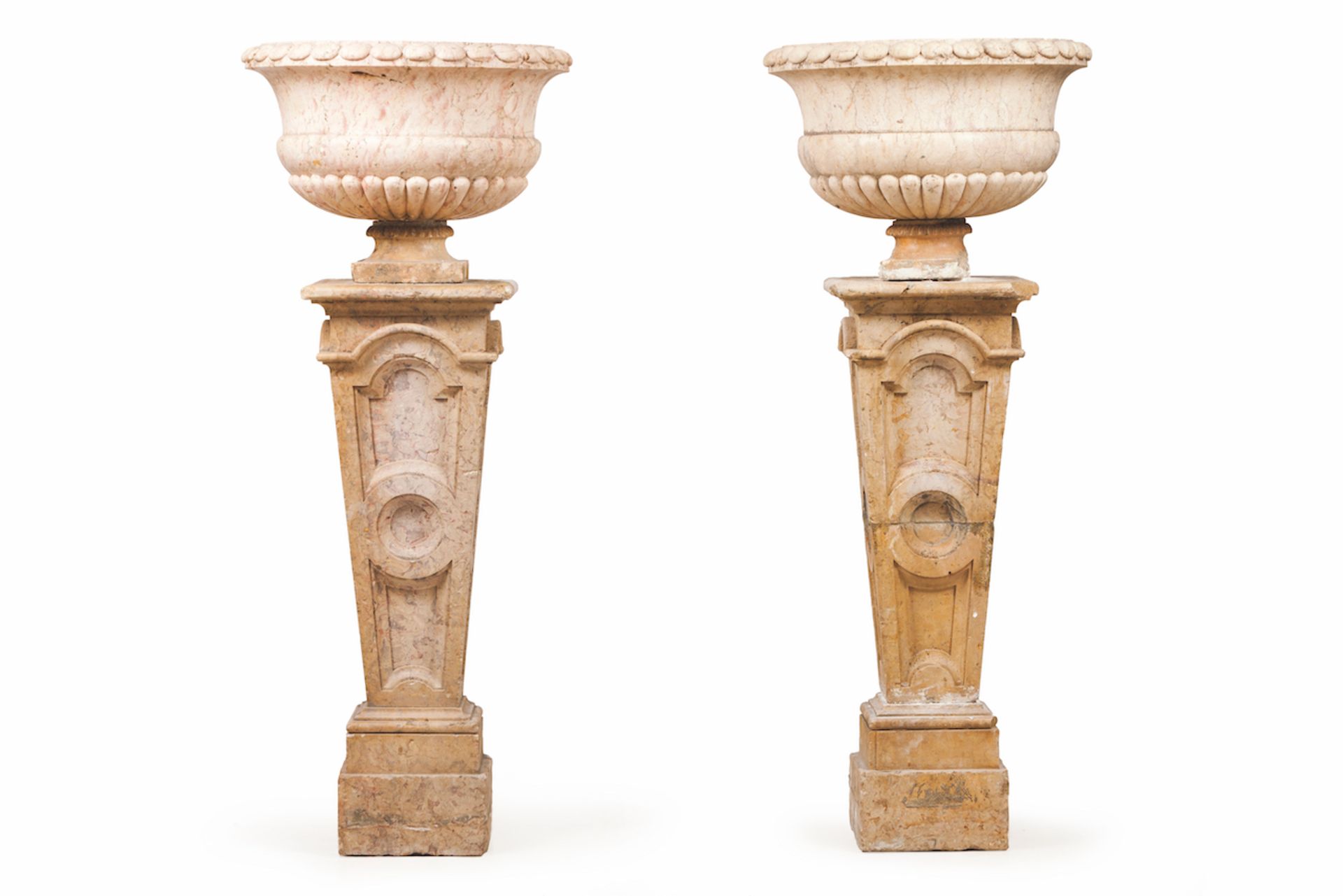 A pair of large vases with pedestalsCarved marbleInverted pyramid shaped pedestal of geometric