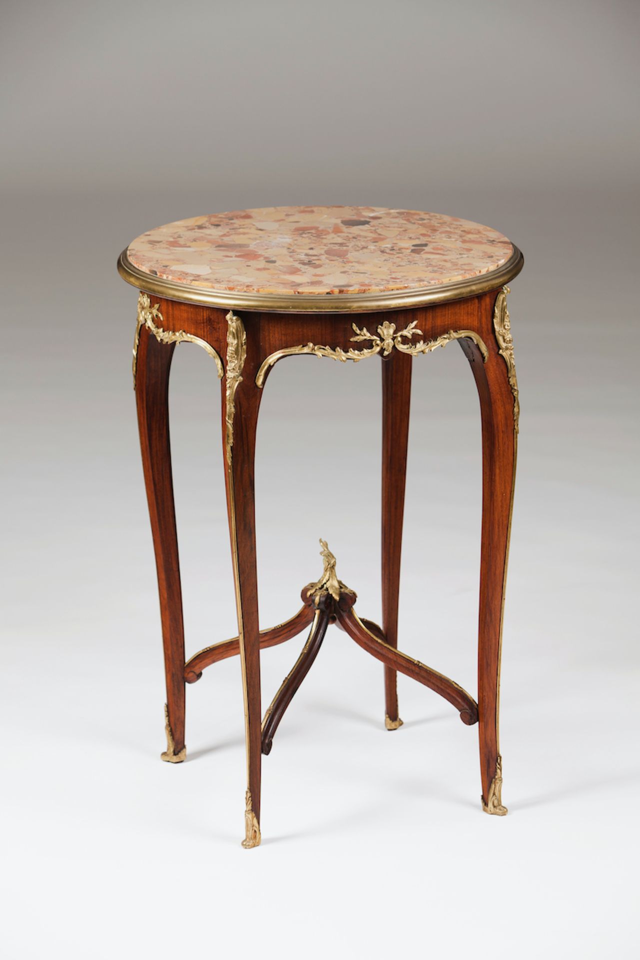 A Louis XV style gueridonSolid and veneered mahoganyYellow metal applied elementsBreccia top19th