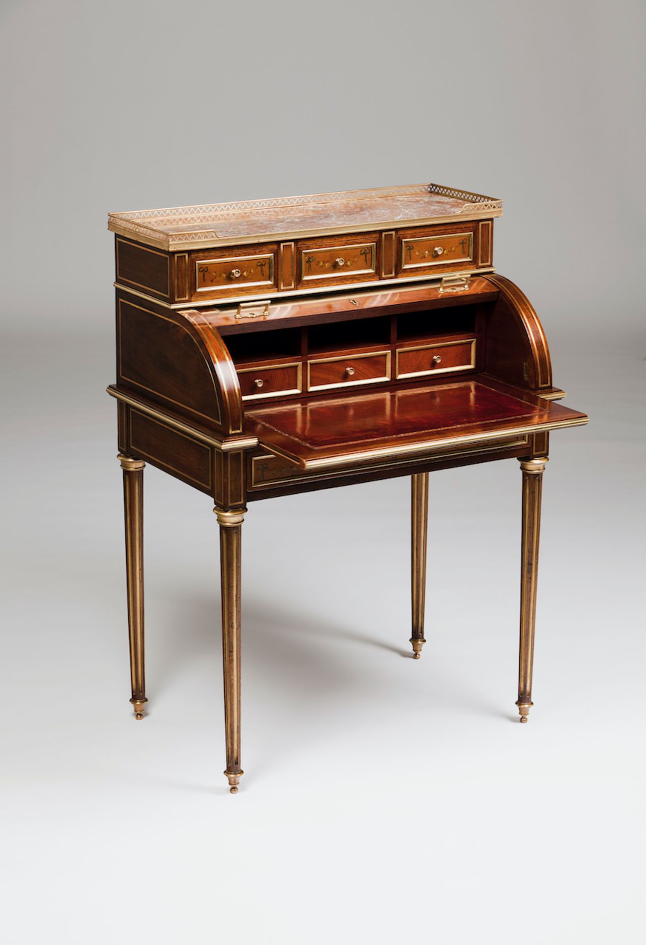 A Louis XVI roll top deskMahogany of inlaid gilt metal decorationUpper section with three drawers