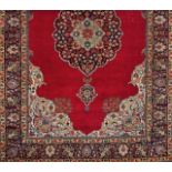 A Tabriz rug, IranWool and cotton of geometric and floral design in bordeaux, blue and beige