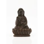 A GuanyinIron sculptureGuanyin seated on a lotus flower, holding a childMing dynastyHeight: 14 cm