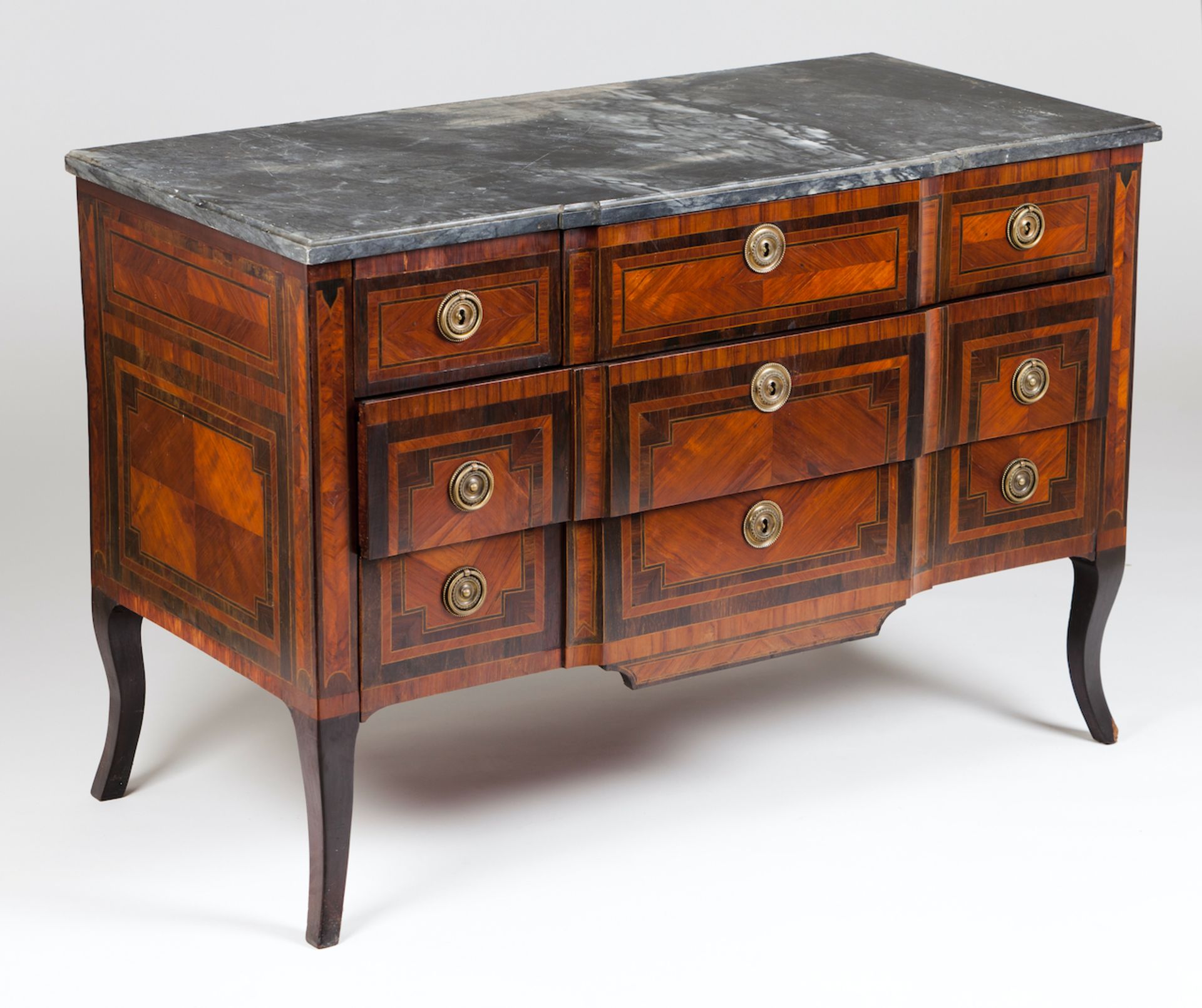 A Louis XVI style commodeRosewood , satinwood and mahogany veneeredProtruding frontThree short and