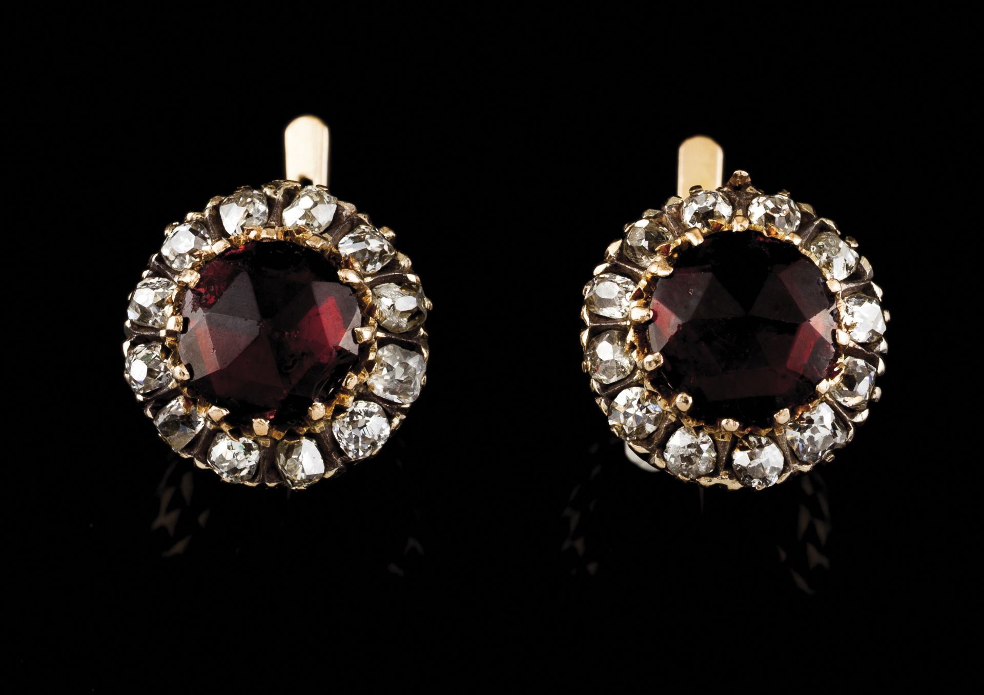 A pair of galleried earringsGoldCentral faux stone framed by 24 antique brilliant cut diamonds