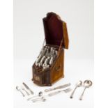 A mahogany knife case with cutlery setSilverPart fluted and monogramed handles12 spoons, 12 forks,