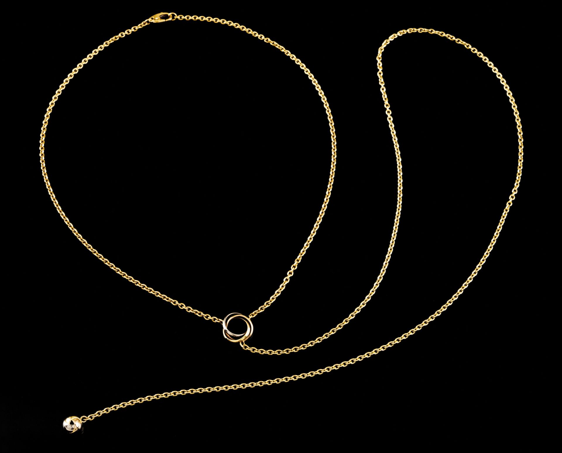 A Cartier necklaceGold mesh 750/1000Small tricoloured gold loop with sphere pendant terminal in