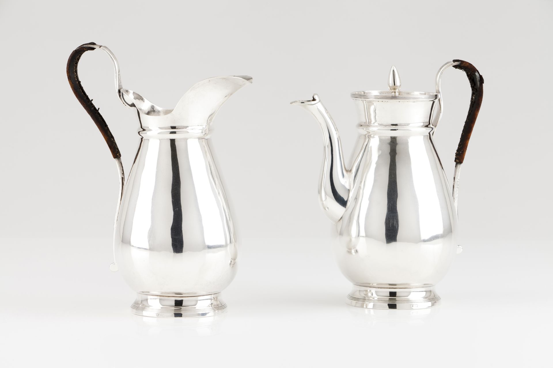 A milk jug and coffee pot with cover