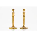 A pair of candle sticks in the manner of Claude Galle (1759-1815)