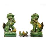 A PAIR OF LARGE SANCAI BUDDHIST LIONS ON STANDS, CHINA, MING DYNASTY AND A SANCAI BRUSH REST, CHINA,