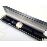 Gents 9ct gold vintage Garrards wristwatch with silver dial and black leather strap with recent