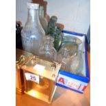 Selection of vintage glass advertising bottles and two brass carriage clocks