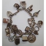 Hallmarked silver charm bracelet 18 charms 88g L: 22 cm