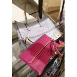 Guess handbag in blue fabric with Guess logo pattern and a clutch bag in pink leather made by Biba