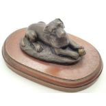 Bronze dog with ball ornament on a wooden base L: 10 cm