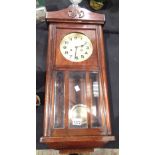 Mahogany wall clock with brass face by Butt and Co Ltd Chester