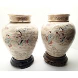 Pair of lidded Oriental jars with covers and lids on carved wooden base H: 20 cm