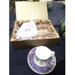 Boxed 2002 Golden Jubilee champagne glasses and a cup and saucer