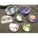 Four unmatched glass paperweights,