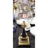 Ornate large candle holder on a black and gold Regency style base with plain glass shade to the top