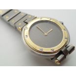 Ladies Cartier stainless steel wristwatch with matching strap and yellow metal bezel