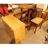 Short chest of three drawers with two circular and one rectangular side tables and a plant stand