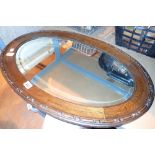 Oak framed bevelled oval mirror