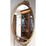 Gilt framed oval mirror with floral decoration