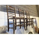 Three ladderback chairs with rush seats