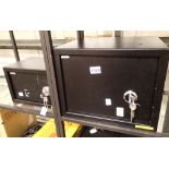 Two black mechanical wall safes 35 x 25 x 25 cm and 31 x 20 x 20 cm (largest has 3 keys, smallest