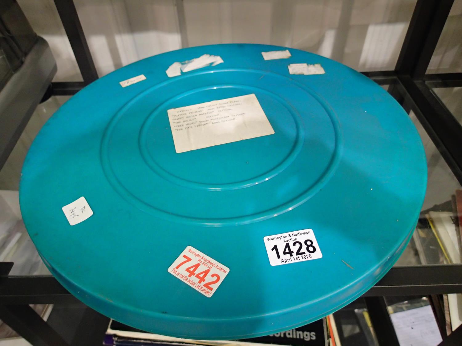 16mm film containing cartoons to include Woody Woodpecker and Andy Pandy and an empty film reel