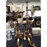 Pair of marble based gilt spelter cupid five-branch candelabra with electric conversion