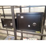 Two black mechanical wall safes 35 x 25 x 25 cm and 31 x 20 x 20 cm (largest has 3 keys, smallest