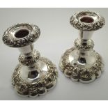 Pair of weighted silver plate on copper fruit decorated candlesticks H: 14 cm