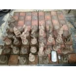 Large terracotta chess set with a four slab board, board 120 cm squared. All pieces present